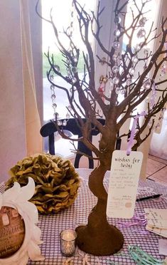 a table topped with a tree next to a basket filled with shells and other items