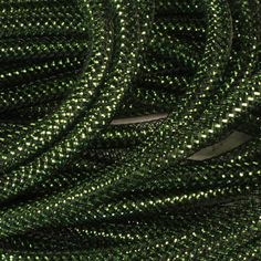 the green and white braided fabric is very close to each other, with small dots on it