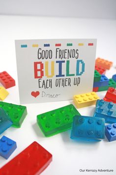 a card that says good friends, build each other up with legos around it