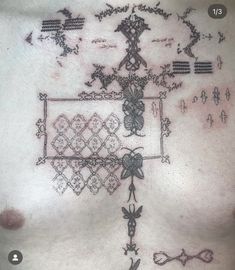 the chest is covered with tattoos and designs