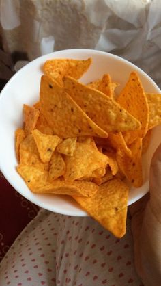 a white bowl filled with tortilla chips