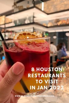 a person holding up a glass with an orange slice in it and the words 8 houston restaurants to visit in jan 2012