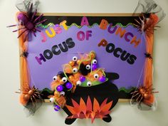 a bulletin board with halloween decorations on it and the words, just a bunch hocus of pocus