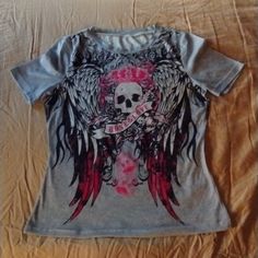 Brand New Tshirt With Gorgeous Skull And Wings In Pink Black And Grey! It's Absolutely Beautiful! Size Small!!!!! Perfect For Spring And Summer! Cute Skeleton Tshirt, Fitted Trendy T-shirt With Skull Print, Y2k Skull Print Crew Neck T-shirt, Y2k Cotton Tops With Skull Print, Y2k Cotton Top With Skull Print, Black Y2k Skull Top, Cotton Y2k Top With Skull Print, Pink Grunge Style Top With Letter Print, Emo Skull Print Short Sleeve Tops