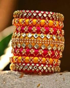 Bangles is an Indian artistic handcraft brand set out to create mesmerizing designs that people would desire to keep and treasure. Every woman is a balance of Beauty, Power & Elegance and we at Bangles aspire to compliment & showcase this Balance. Indian Beauty resides in vibrant colors and soothing elegance, two things that traditionally don't mix together. Elegance demands tranquility while Vibrancy demands energy. Bride And Groom Name Bangles Multicolor Bracelets With Motifs As Gift, Multicolor Bracelets With Motifs For Gifts, Multicolor Motifs Bracelet As Gift, Multicolor Motif Bracelets, Handmade Pink Bracelets For Diwali, Pink Handmade Bracelet For Diwali, Handmade Pink Bracelet For Diwali, Multicolor Cutdana Bracelets As Gifts, Pink Handmade Traditional Bangle