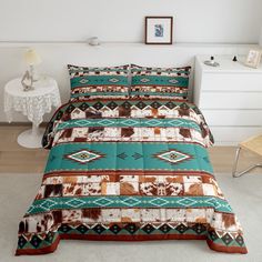 a bed covered in a green and brown comforter next to a night stand with a lamp