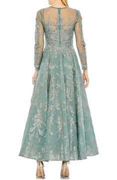 Illusion lace makes a delicate backdrop for the glittering garden that defines this absolutely lovely gown. Jewel neck Long sleeves Lined 100% polyester Spot clean Imported Asian Owned/Founded Crochet Jackets, Embellished Cocktail Dress, Mother Dresses, Unique Prom Dresses, Designer Prom Dresses, Prom Designs, Peach Fuzz, High Quality Dress, Mac Duggal