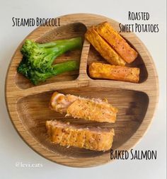 a wooden plate with broccoli, meat and bread on it that says steamed broccoli roasted sweet potatoes baked salmon