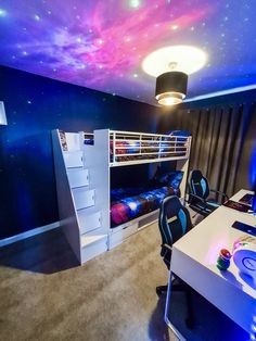 a bedroom with a bunk bed, desk and chair in front of a space themed ceiling