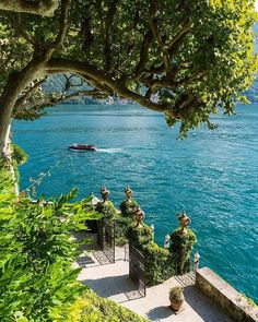 some people are sitting on benches by the water