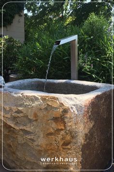 a stone fountain with water coming out of it