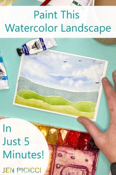 a person is painting with watercolors on paper and the words paint this watercolor landscape in just 5 minutes