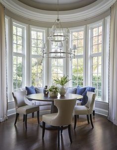 a dinning room table with chairs around it