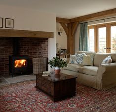 a living room filled with furniture and a fire place