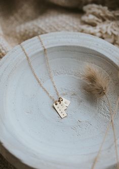 We updated our origina Mama Necklace to a shorter more modern bar design and added square pendant add-ons for the initials of your favorites. She’s still simple and minimal and full of very special meaning. Rectangle pendant measures 16mm long and is hand-stamped in a tiny uppercase block font. Bar is lightly brushed with steel wire for a matte finish. Our 6x9mm discs are hand-stamped with one heart or one initial per disc in an uppercase sans-serif font. Discs are suspended from a 16" or 18" de Cheap Hand Stamped Name Necklace Gift, Everyday Gold Necklace, Modern Bar Design, Necklace Photography, Mom Necklace Personalized, Nick Nacks, Classy Girls Wear Pearls, Copper Uses, Everyday Wear Jewelry