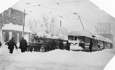 an old black and white photo of people standing in the snow next to a train