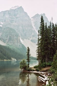 a lake surrounded by trees and mountains