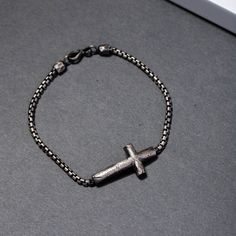 "A brutalist bracelet with a handmade cross on a round box chain in oxidized sterling silver 925. A great choice for a birthday gift for him or for groomsmen gift idea. F E A T U R E S * Metal: High-quality Sterling Silver 925 * Finish: Oxidized Silver * Width: 2.5mm * Cross: 30 mm x 18mm * Length: 7.5 - 9 inches  100% nickel free. Delivered in an elegant gift package! S H I P P I N G All orders are shipped via FedEx Express for speed and security (delivery time to the US 3-5 days, Europe 1-2 da Gunmetal Chain Bracelet As Gift, Black Oxidized Chain Bracelet As Gift, Black Oxidized Finish Chain Bracelet For Gift, Gift Black Oxidized Chain Bracelet, Gunmetal Box Chain Bracelet As A Gift, Silver Cross Chain Bracelet As Gift, Men Bracelets, Men Bracelet, Bracelet Men