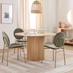 a dining room table with four chairs around it