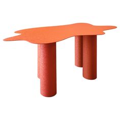 an orange table sitting on top of a white floor