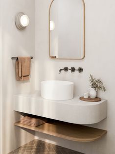 a bathroom with a sink, mirror and towel rack