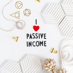 i love passive income written on paper surrounded by gold and white decorations