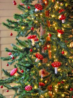 the christmas tree is decorated with red and white ornaments