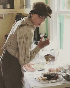 a woman standing in front of a table filled with food