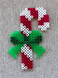 two red and green christmas decorations made out of legos