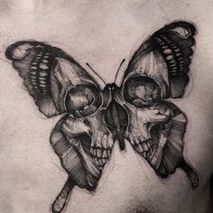 a black and white image of a butterfly with skulls on it's back shoulder