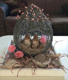 two little birds in a birdcage with pink roses