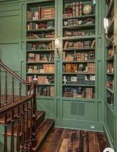 the bookshelves are full of many different types of books in this green room