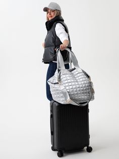 Perfect your on-the-go lifestyle with Shiraleah’s Logan Travel Tote. This roomy tote features a sleek silver metallic fabric that goes with any outfit for an elevated yet casual look. With both double handles and a detachable, adjustable cross-body strap it is versatile enough for every occasion, and its spacious interior and multiple pockets allow you to carry everything in one place. It even has an outer trolley sleeve for hands-free traveling! Pair with matching items from the brand new line Silver Bags With Detachable Strap For On-the-go, Silver Tote Shoulder Bag For On-the-go, Metallic Travel Tote Bag, Metallic Tote Bag For Travel, Versatile Silver Bag For On-the-go, Metallic Shoulder Bag For Travel, On-the-go Travel Bag With Handles, Silver Double Handle Shoulder Bag For Travel, Silver Functional Bag For Everyday Use