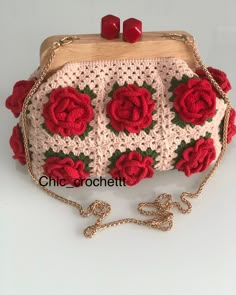 a crocheted purse with red roses on it