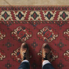 a person standing on top of a rug with their feet propped up against the carpet