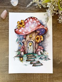 a watercolor painting of a mushroom house with flowers on the ground next to it