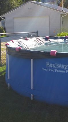 an above ground swimming pool in front of a house with the bestway logo on it