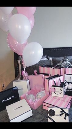 a bunch of pink and white boxes with balloons