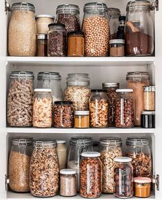 an organized pantry filled with lots of different types of food and spices in glass jars