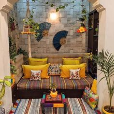 a living room filled with lots of furniture and plants