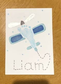 a hand is holding up a card with an image of a plane and the word lion on it