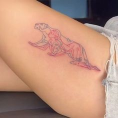 a woman's thigh with a tattoo on the side of her leg that has a drawing of two lions