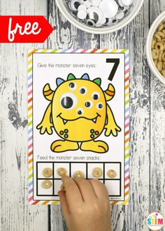 a child's hand holding up a printable number seven monster