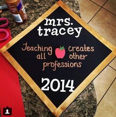 a black and gold graduation cap with the words mrs tracley on it next to scissors