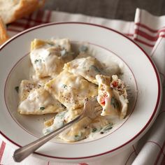 a white plate topped with ravioli and cheese