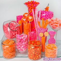 there are many candies and candy in the glass vases on the table together