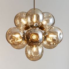 a chandelier hanging from a ceiling with many lights on it's sides