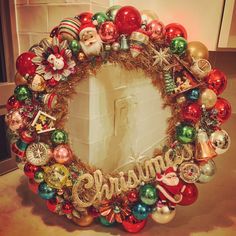 a christmas wreath with ornaments around it