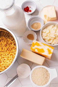 ingredients to make macaroni and cheese are shown in bowls on a white table