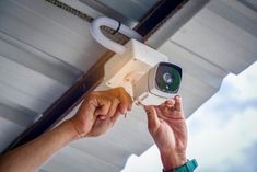 a person holding a camera up to the ceiling